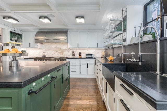 kitchen featuring white cabinetry, green cabinetry, tasteful backsplash, dark hardwood / wood-style floors, and wall chimney range hood