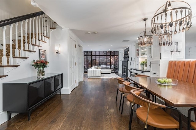 dining room with floor to ceiling windows and dark hardwood / wood-style floors