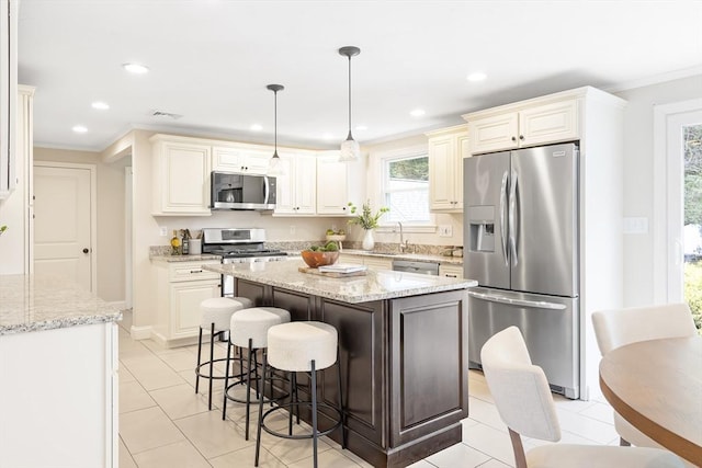 7 Langdon Rd, Natick, MA 01760 - kitchen featuring appliances with stainless steel finishes, crown molding, a breakfast bar, a sink, and light tile patterned floors