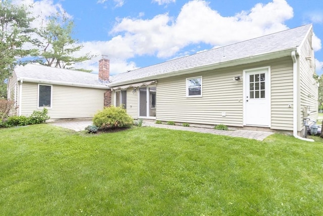 7 Langdon Rd, Natick, MA 01760 - rear view of house featuring a lawn and a chimney