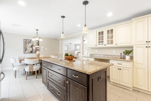 7 Langdon Rd, Natick, MA 01760 - kitchen with cream cabinetry, decorative columns, dark brown cabinets, glass insert cabinets, and light tile patterned flooring