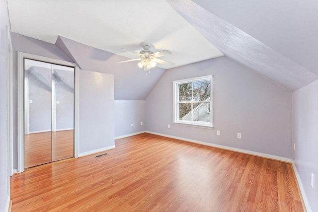 additional living space with ceiling fan, lofted ceiling, and light wood-type flooring