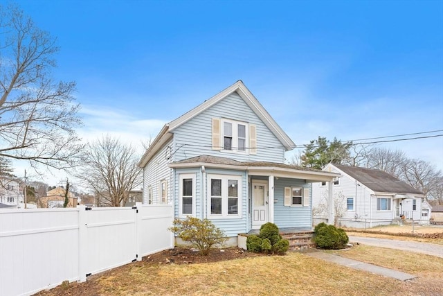 bungalow featuring a front lawn and a porch