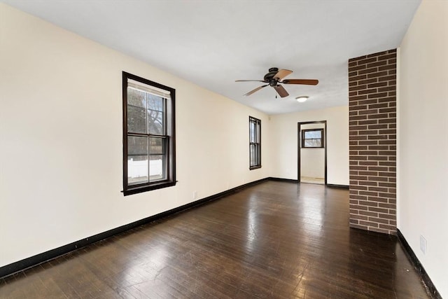 spare room with ceiling fan, dark hardwood / wood-style flooring, and a healthy amount of sunlight