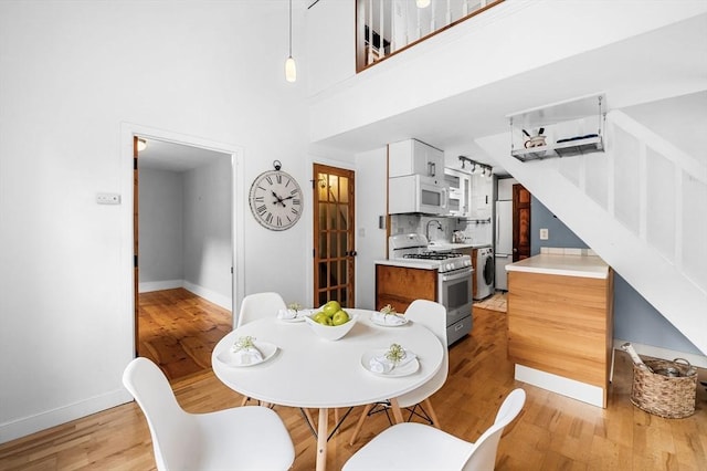 23 Turner St Unit 4, Salem, MA 01970 - dining room featuring light wood-style floors and a towering ceiling