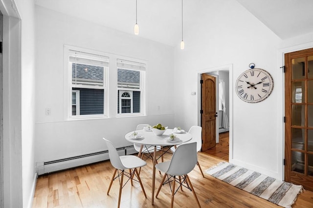 23 Turner St Unit 4, Salem, MA 01970 - dining room featuring a baseboard heating unit, wood finished floors, and lofted ceiling
