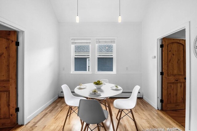 23 Turner St Unit 4, Salem, MA 01970 - dining space featuring light wood-style flooring, a baseboard radiator, and vaulted ceiling
