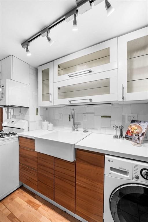 23 Turner St Unit 4, Salem, MA 01970 - kitchen featuring washer / clothes dryer, white appliances, rail lighting, and light countertops