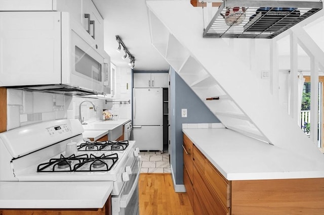 23 Turner St Unit 4, Salem, MA 01970 - kitchen featuring white appliances, light wood-style floors, light countertops, and track lighting
