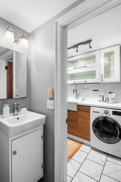 23 Turner St Unit 4, Salem, MA 01970 - bathroom featuring washer / clothes dryer, vanity, and marble finish flooring