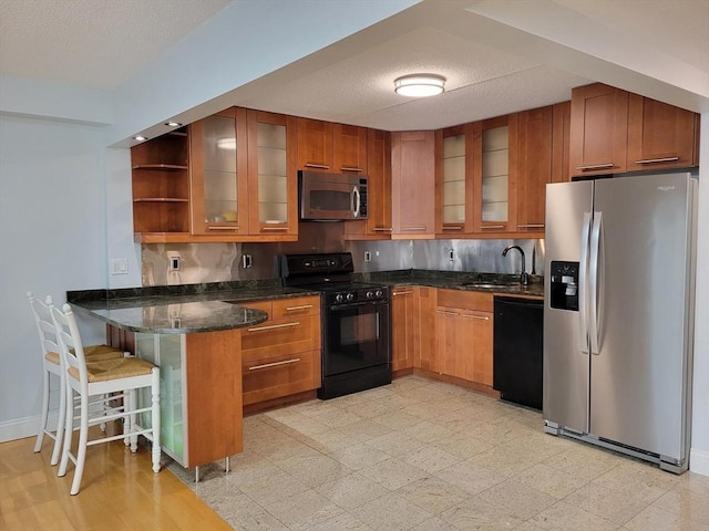 200 Cove Way Unit 607, Quincy, MA 02169 - kitchen with black appliances, a peninsula, brown cabinetry, open shelves, and dark stone countertops