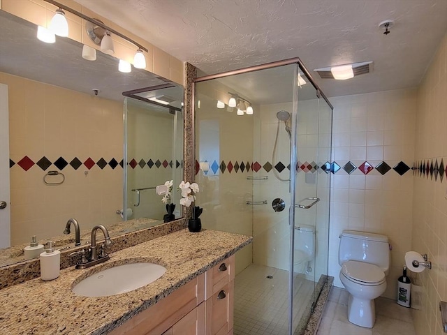 200 Cove Way Unit 607, Quincy, MA 02169 - bathroom featuring tile walls, tile patterned flooring, vanity, and a stall shower