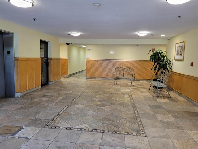 200 Cove Way Unit 607, Quincy, MA 02169 - spare room with wainscoting, a smoke detector, inlaid floor details, elevator, and fire sprinkler in ceiling