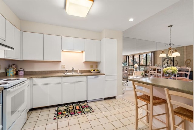 kitchen featuring white cabinetry, sink, and white appliances