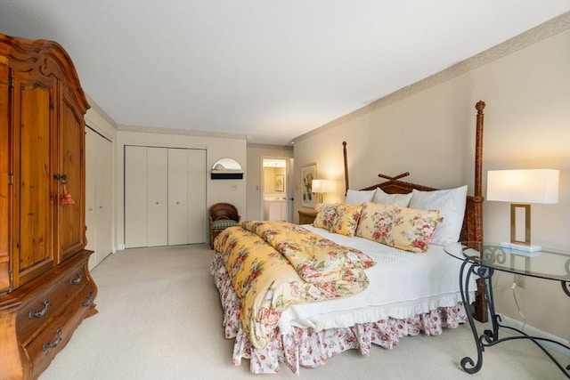 bedroom featuring a closet, ornamental molding, and light colored carpet