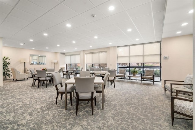 dining area featuring carpet and expansive windows