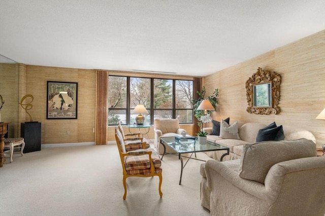 carpeted living room with wood walls and expansive windows