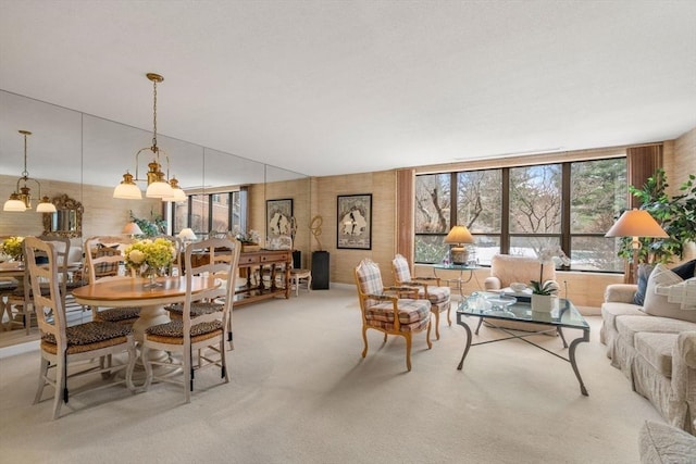 living room featuring light carpet and a notable chandelier