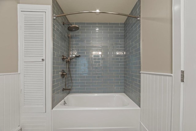 full bath featuring a closet,  shower combination, and wainscoting