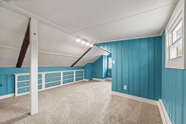 additional living space featuring carpet flooring, a baseboard heating unit, and lofted ceiling