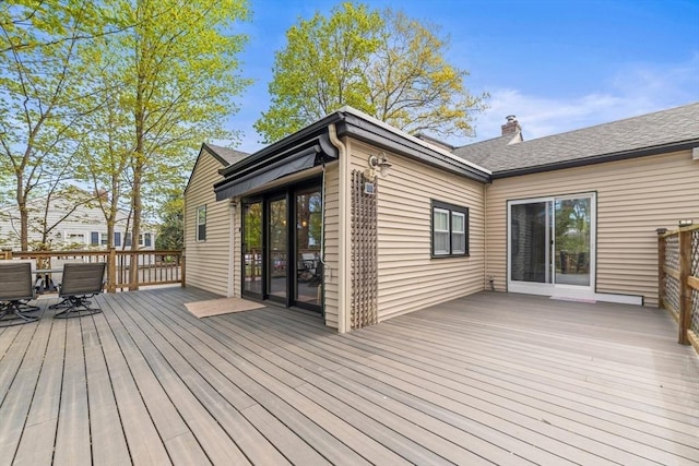 wooden terrace featuring outdoor dining area