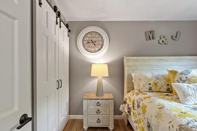 14 Mossman Rd, Westminster, MA 01473 - bedroom with a barn door, a closet, dark wood-style flooring, and baseboards