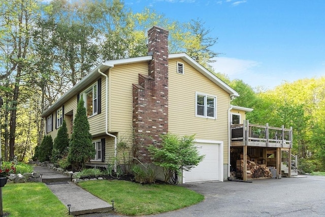 14 Mossman Rd, Westminster, MA 01473 - view of side of home featuring a chimney, an attached garage, a wooden deck, asphalt driveway, and stairway