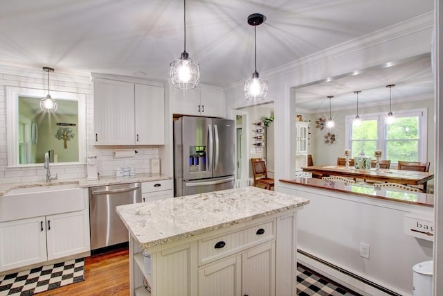 14 Mossman Rd, Westminster, MA 01473 - kitchen with appliances with stainless steel finishes, a sink, a baseboard heating unit, a center island, and decorative backsplash