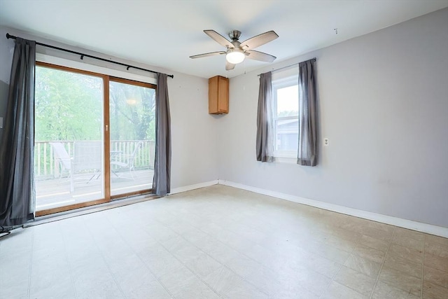 unfurnished room featuring ceiling fan, light flooring, and baseboards