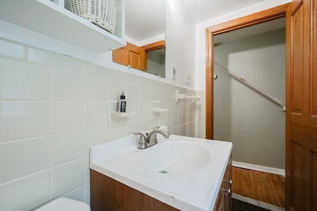 bathroom with vanity, tile walls, toilet, and wood finished floors