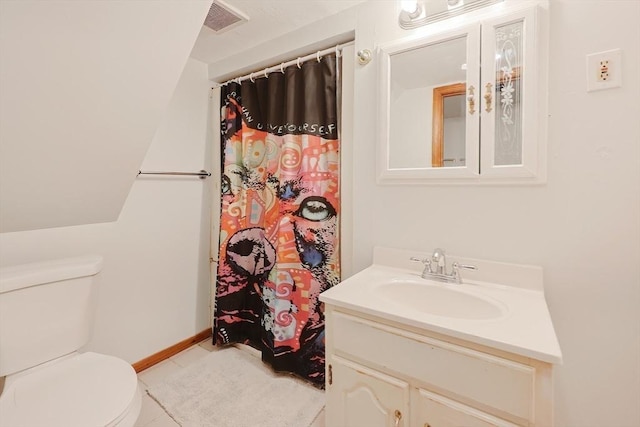 bathroom with toilet, vanity, and a shower with curtain