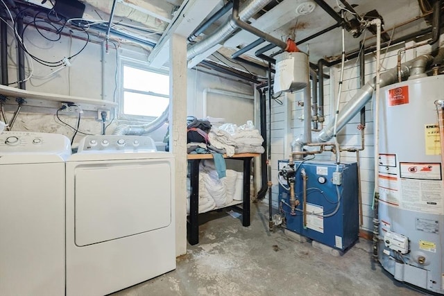 basement featuring water heater, washer and dryer, and a heating unit