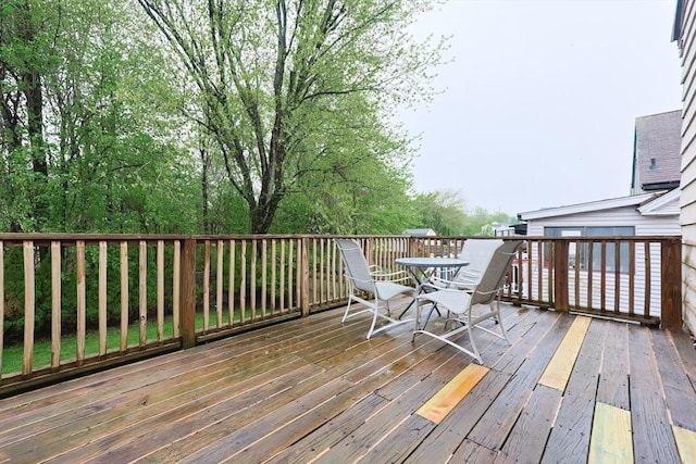 wooden deck featuring outdoor dining area