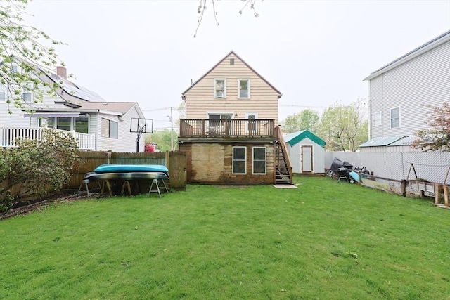 rear view of property with stairs, a storage shed, an outdoor structure, a wooden deck, and a swimming pool
