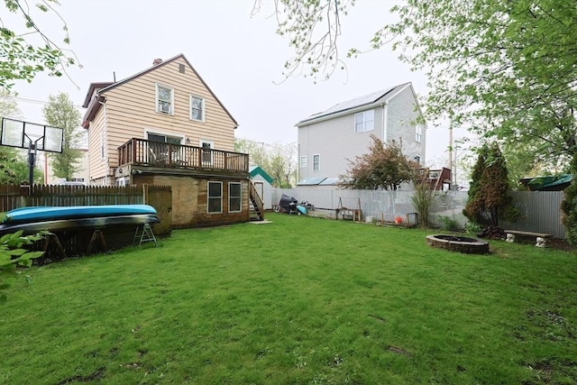 rear view of property with a fire pit and a wooden deck