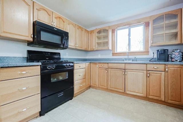 kitchen with black appliances, light brown cabinetry, a sink, glass insert cabinets, and light floors
