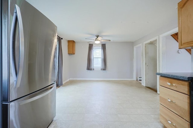 kitchen featuring freestanding refrigerator, a ceiling fan, baseboards, light floors, and a baseboard radiator
