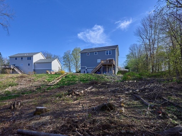 back of house featuring a deck and stairway