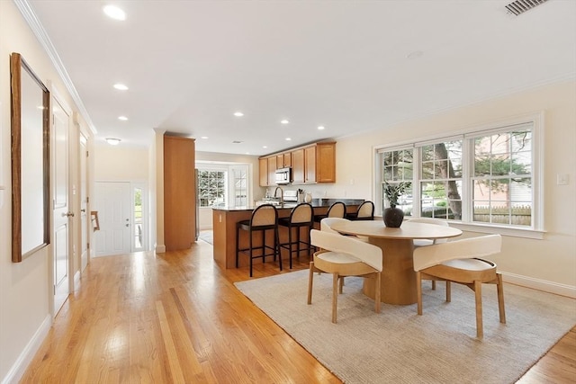 51 Loomis St Unit 51, Cambridge, MA 02138 - dining space with ornamental molding, light wood finished floors, and recessed lighting
