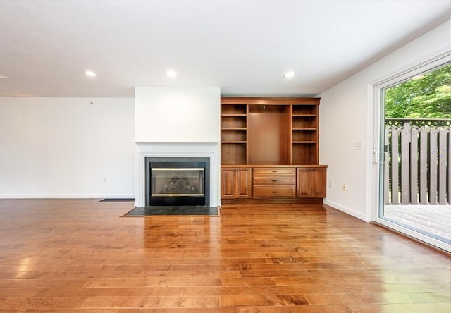 9 Longwood Rd Unit 239, Mashpee, MA 02649 - unfurnished living room with light wood-style floors, a fireplace with flush hearth, baseboards, and recessed lighting