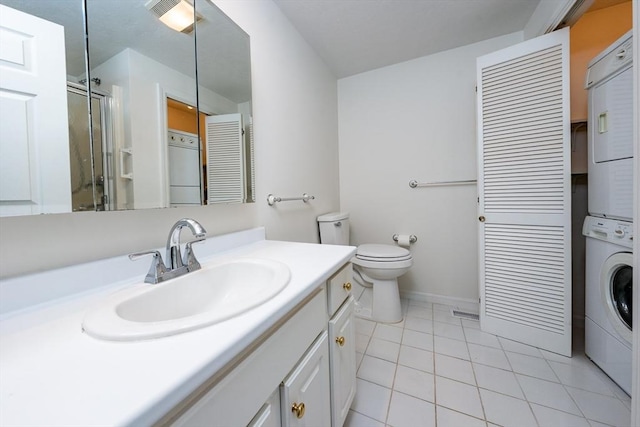 9 Longwood Rd Unit 239, Mashpee, MA 02649 - full bath featuring stacked washing machine and dryer, tile patterned flooring, vanity, a shower with shower door, and toilet