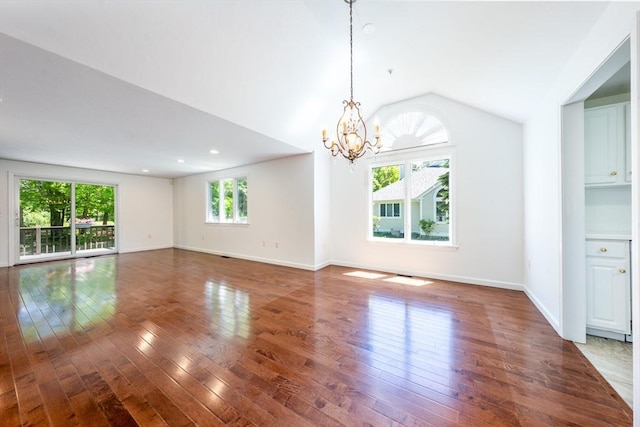 9 Longwood Rd Unit 239, Mashpee, MA 02649 - unfurnished living room featuring healthy amount of natural light, hardwood / wood-style flooring, a chandelier, and lofted ceiling