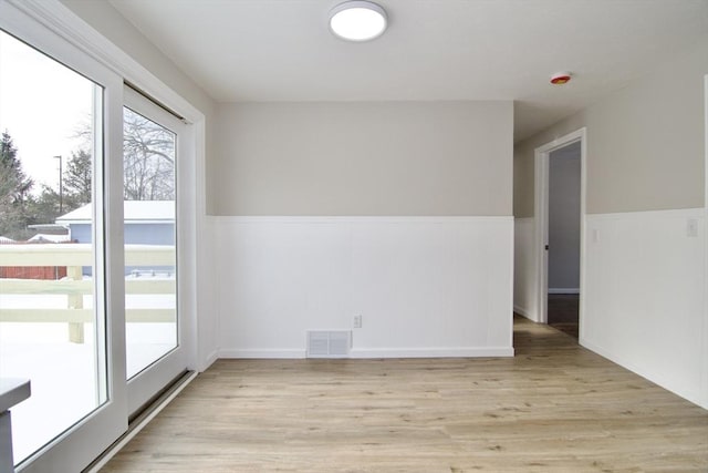 spare room featuring light hardwood / wood-style floors