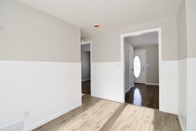 spare room featuring light hardwood / wood-style flooring