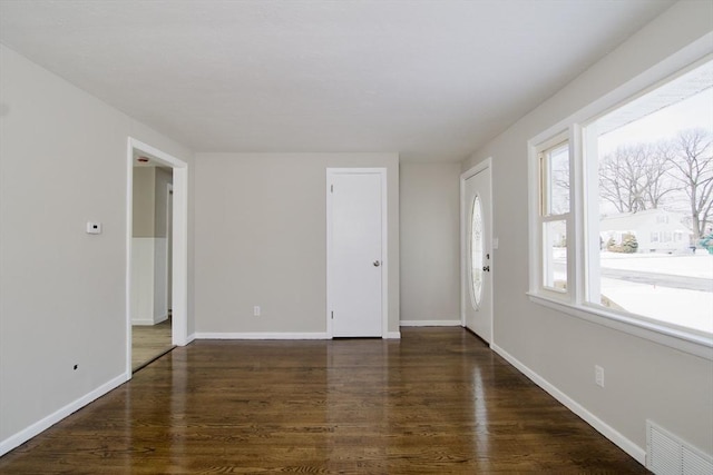 spare room featuring dark wood-type flooring