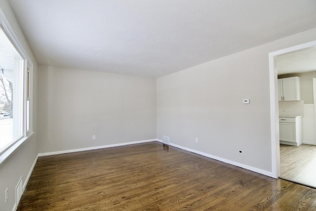 spare room featuring dark hardwood / wood-style flooring