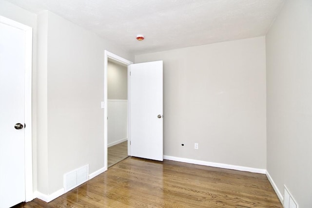 unfurnished bedroom with hardwood / wood-style floors