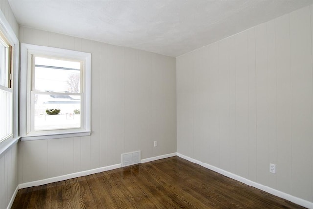 unfurnished room featuring dark wood-type flooring