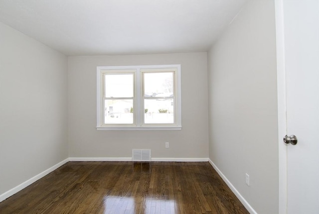 empty room featuring dark hardwood / wood-style flooring