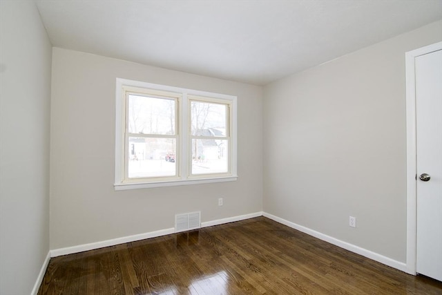 unfurnished room featuring dark hardwood / wood-style flooring